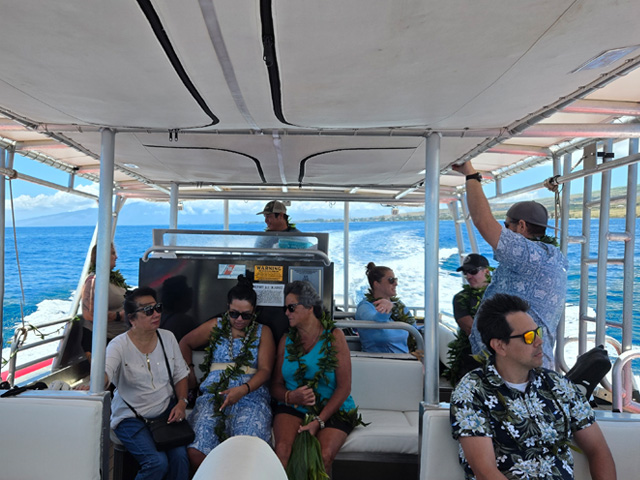 Trip members relaxing inside the boat during an ocean tour. Trip members relaxing inside the boat during an ocean tour.